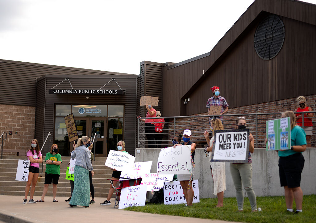 Protesters stand outside the Columbia School Board meeting